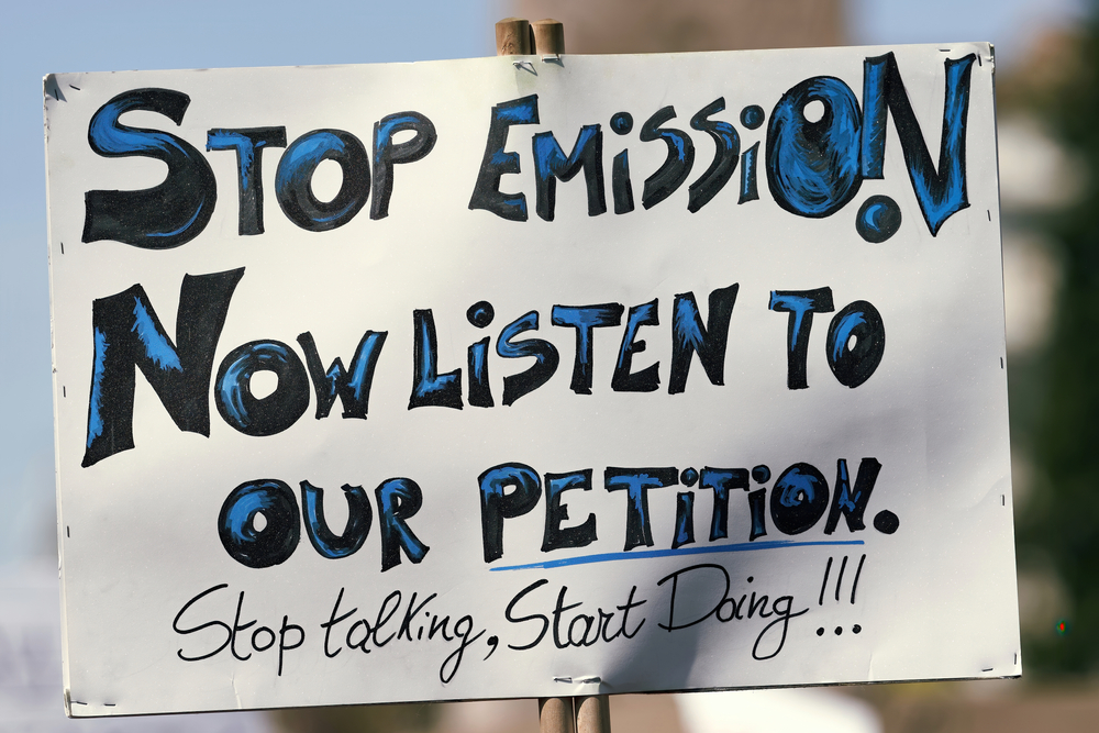 Sign says: Stop Emissions Now listen to our petition