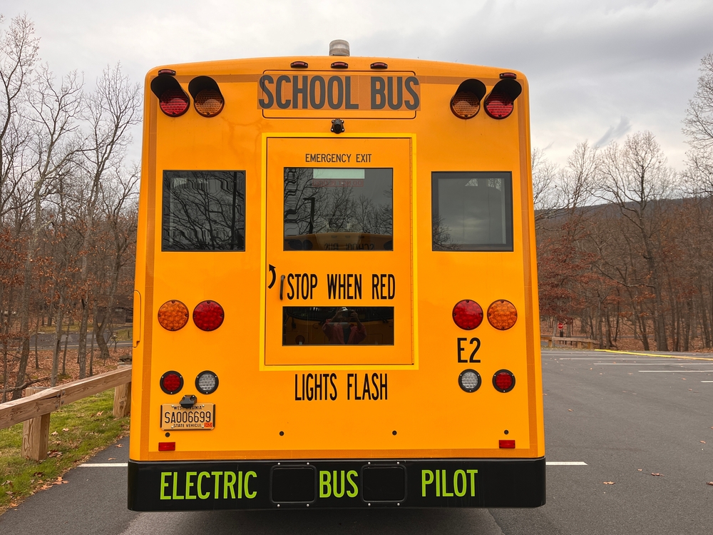 Rear view of yellow electric school bus, part of a pilot program in West Virginia