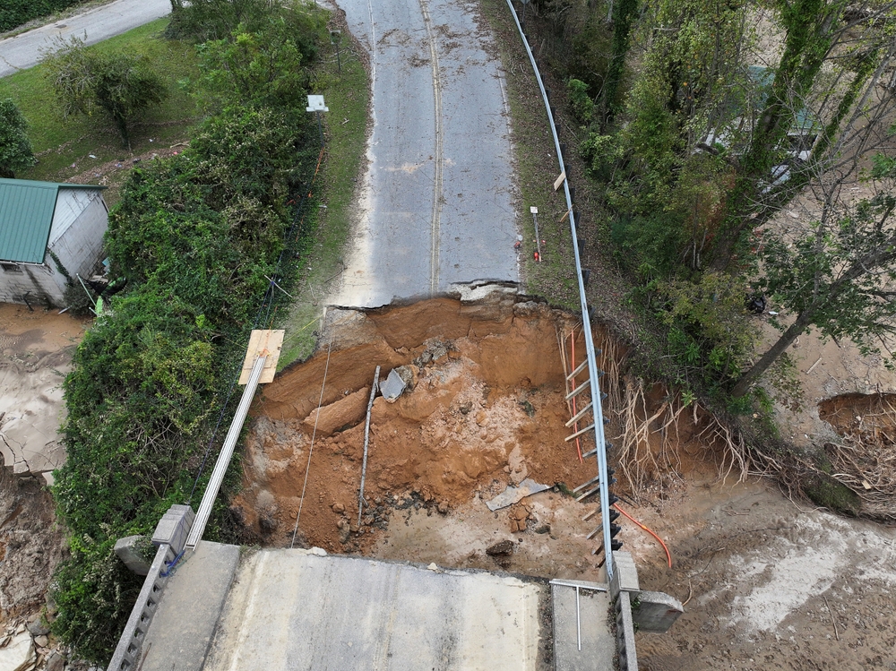 Section of North Carolina road washed away during the climate crisis created during Hurricane Helene 
